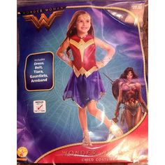 a girl in a wonder costume standing on top of a purple sheet with the words wonder written