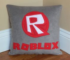 a pillow with the word roblex on it sitting in front of a wall