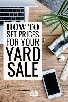 a yard sale sign sitting on top of a wooden table next to a laptop computer