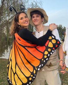 a man and woman are dressed up as a butterfly