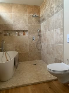 a bathroom with a tub, toilet and sink in it's shower stall area