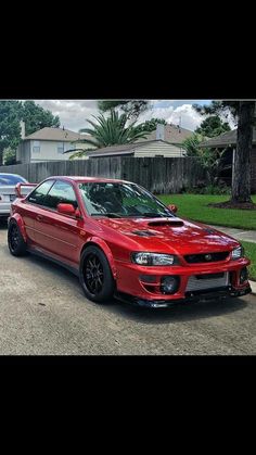 two red cars parked next to each other