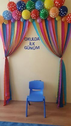 a blue chair sitting in front of a balloon arch