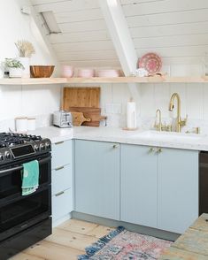 a kitchen with blue cabinets and white walls