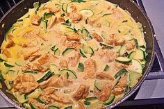 a pan filled with food sitting on top of a stove