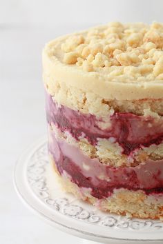 a layered cake on a plate with crumbs