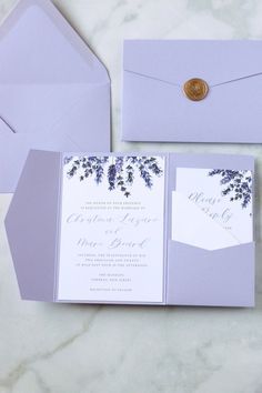 the wedding stationery is set up with purple envelopes