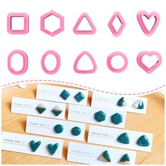 several different shapes and sizes of cookie cutters on a table with thank you note cards