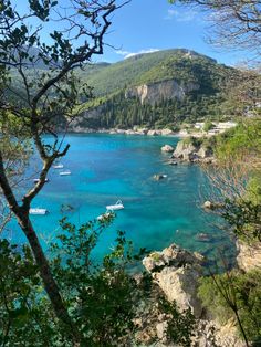 boats are floating in the clear blue water