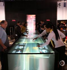 people standing around looking at an interactive display