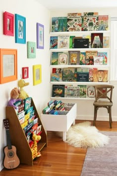 a child's room with bookshelves and toys on the wall, including a toy guitar