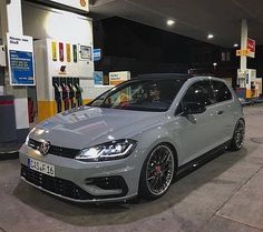 a silver car parked in front of a gas station