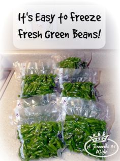 several bags of fresh green beans sitting on top of a counter next to a sign that says, it's easy to freeze fresh green beans