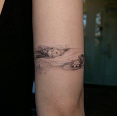 a woman's arm with a tattoo on it that has an image of a woman