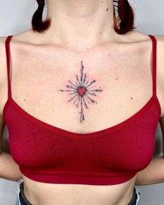 a woman with a heart tattoo on her chest