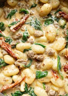 pasta with spinach and sausage in a white sauce