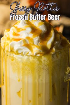 a close up of a frozen butter beer in a glass with whipped cream and caramel drizzle