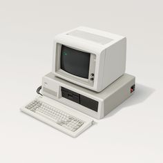 an old computer sitting on top of a white desk