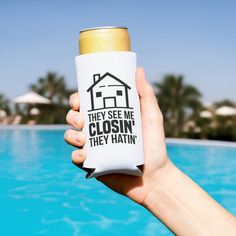 a person holding up a can in front of a pool that says, they see me closing they hitin '