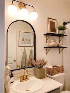 a bathroom with a sink, mirror and shelves on the wall in front of it