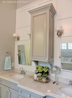 a bathroom with two sinks and a large mirror