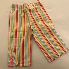 Vertical Striped Capri Pants In Bright Rainbow Fruit Colors - Red, Orange, Yellow, Green, Blue And Pink. Has Pretty Pink Lace Ties On Bottoms. From The Gymboree Tutti Fruity Line. Fun Multicolor Pants For Spring, Fun Multicolor Spring Pants, Playful Multicolor Spring Pants, Colorful Playful Bottoms For Spring, Cute Multicolor Cotton Bottoms, Playful Multicolor Bottoms For Spring, Playful Orange Bottoms For Spring, Fun Red Bottoms For Spring, Fun Multicolor Cotton Bottoms