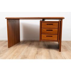 a wooden desk with three drawers on it