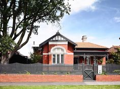 a large brick house with a gate in front of it