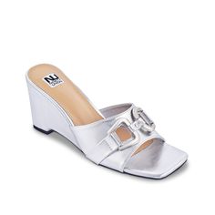 Ninety Union-Kensy Wedge Sandal Touch up your warm weather look with the sleek Kensy sandal from Ninety Union. This wedge pair sports a mule-inspired silhouette with metallic bit detailing for some glitz. Summer Silver Heels With Buckle Closure, Silver Heels With Buckle Closure For Summer, Silver Heels With Buckle Closure, Modern Silver Open Toe Mules, Silver Slip-on Wedge Sandals For Spring, Silver Synthetic Wedge Sandals For Summer, Casual Silver Wedge Sandals For Summer, Silver Sandals With Buckle Closure For Summer, Silver Slip-on Wedge Sandals