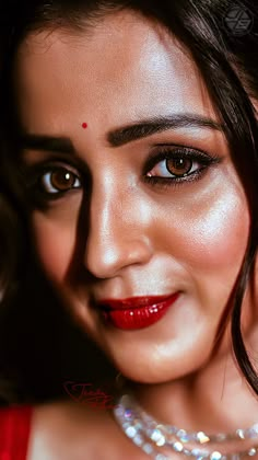 a close up of a woman with red lipstick and pearls on her head wearing a necklace