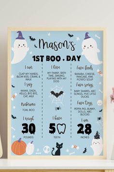 a blue poster with the words mason's 1st boo day on it and halloween decorations