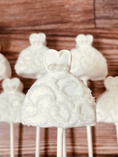 wedding cake pops with white frosting on them