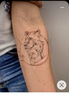 a woman's arm with a drawing of two lions on the back of it