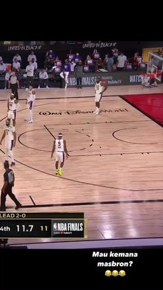 a group of men playing basketball on a court