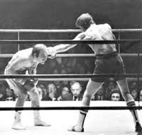 two men are boxing in an old photo