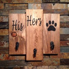 two wooden plaques with paw prints on them that say his and hers, one has a dog's paw