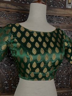 Boat Neck Pure Banarasi Bottle Green Color Blouse with Gold Buttis. Comes with Cups attached to the blouse. Item : Blouse Size : 36 (Can be opened to Size 42) Size : 40 (Can be opened to Size 44) Color : Bottle Green Blouse Fabric : Pure Banarasi Blouse Fitting : Princess Cut Lining : Yes, it is fully lined Padded or Non-Padded : Padded Closure: Back Closure with hooks. Ready-to-Wear : Yes Please note : This is a Standard Size blouse. We do not guarantee perfect fit as every body and shape is di Luxury Green Kalamkari Blouse Piece, Gold Banarasi Silk Blouse, Banarasi Silk Lehenga With Padded Blouse, Long Sleeve Banarasi Silk Blouse For Eid, Green Padded Blouse Traditional Wear For Festivals, Traditional Wear With Padded Blouse For Festivals, Green Traditional Wear With Padded Blouse For Festivals, Festival Traditional Wear With Padded Blouse, Festive Banarasi Silk Traditional Wear With Padded Blouse