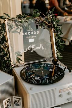 an old record player sitting on top of a table