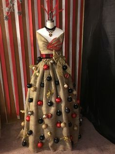 a dress made out of fabric with red, black and gold decorations on the skirt