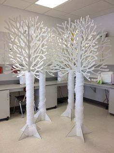 an image of some white trees in the middle of a cubicle with chairs and desks