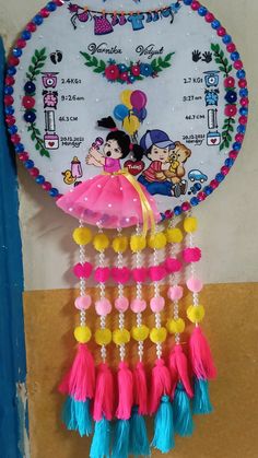 a wall hanging made out of plastic beads and tassels with mickey mouse on it