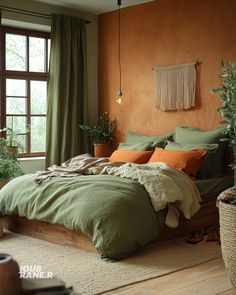 a bed with green sheets and pillows in a room next to a window, potted plants on the floor