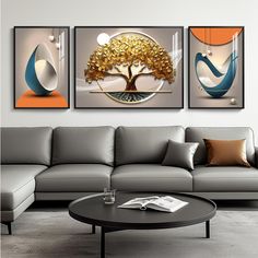 three paintings are hanging on the wall above a couch and coffee table in a modern living room