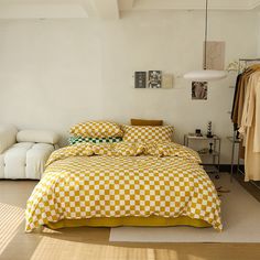 a yellow and white checkered comforter on a bed