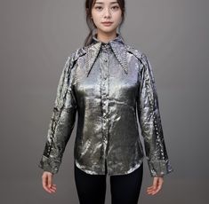 Elevate your style with this stunning Women's Shimmery Silver Shirt, adding a touch of glamour to any outfit. The shirt features a unique rough, textured finish that catches the light beautifully, giving you a dazzling look. The long pointed collar and sleeves are adorned with elegant stones, adding a sophisticated sparkle. Whether you're dressing up for a night out, a special event, or just want to add some flair to your everyday wardrobe, this silver metallic shirt is the perfect choice.  SIZE: Free Size (suitable for girls who weigh 45-65 kg) Bust: 40 inch Sleeve: 24 inch Length: 27.5 inch Crafted with attention to detail and quality, it's both stylish and comfortable, making it a must-have addition to your fashion collection. Metallic Shirt, Sleeves For Women, Silver Shirt, Silver Blouse, Everyday Wardrobe, Special Event, Womens Clothing Tops, Fashion Collection, Halloween Shopping