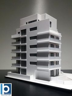 an architectural model of a building on a table