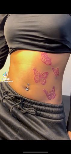 a woman's stomach with butterflies on it and the bottom part of her belly