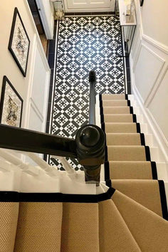 the stairs are lined with black and white tile