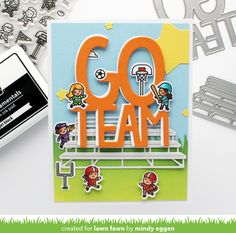 a card with the word go team on it next to some other cards and paper cutters