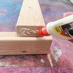 the glue is being used to make a piece of wood look like it has been painted